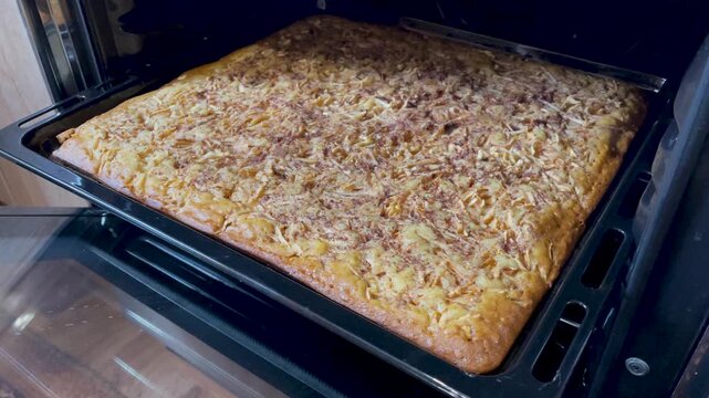 Apple charlotte on a baking sheet in the oven