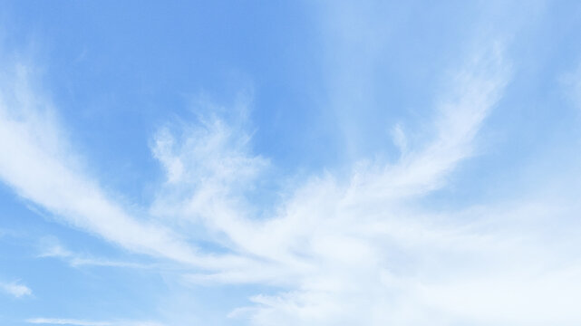 Bright blue sky background filled with soft, white cumulus clouds during daytime. Perfect for nature backdrop, weather concepts, spiritual themes, and outdoor freedom projects
