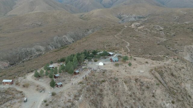 Aerial drone footage approaching Observatorio Astronomico Ampimpa surrounded by the arid mountains of Tucum&aacute;n, Argentina.