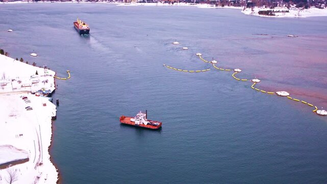 Winter aerial footage of a vehicle ferry operating in northern Michigan.