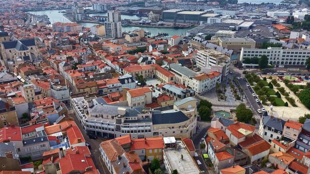 Panning drone fly of Les Sables-d&rsquo;Olonne harbor part downtown with Liberty Square with Quai Ernest de Franqueville area in background, Vend&eacute;e, France