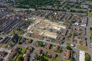 Obraz premium Aerial view of a residential redevelopment construction site in Sunderland showing new housing foundations active building work surrounding neighbourhood streets and a prominent church urban landscape