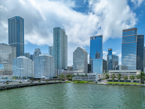 Aerial view of modern skyscrapers and high-rise buildings along the waterfront under a cloudy sky in Downtown Miami, Florida, United States.