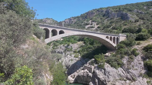Pont du Diable Bridge Spanning Verdant Gorge in Occitanie, France