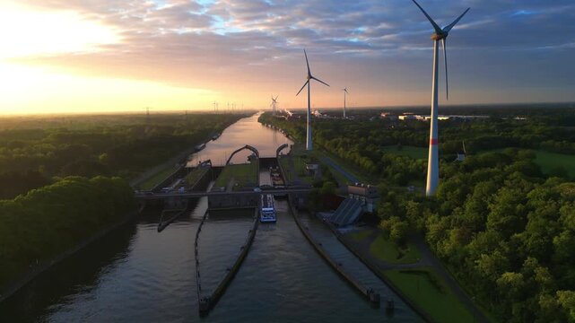 Aerial Drone Footage of Canal Lock with Cargo Ship and Wind Turbines at Sunset in Herentals Belgium