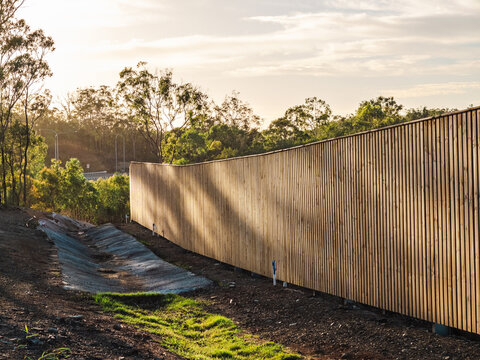 Wooden fence next to drainage ditch