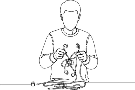 Person holding and examining tangled earphones carefully.