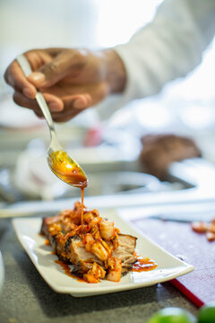 Close-up of chef making pork belly and kimchee in restaurant