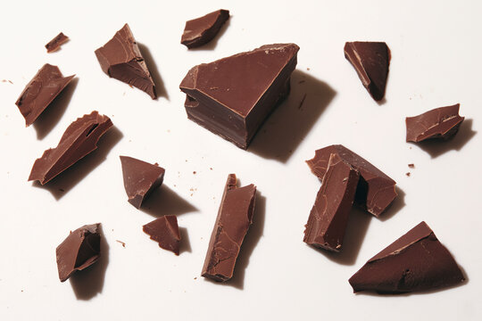 Broken block of chocolate on white background