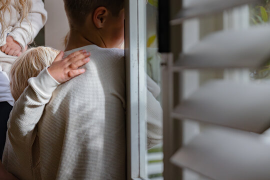 Younger brother with his hand on his old brother's shoulder in a touching moment