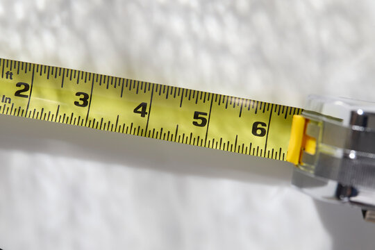 Close-up of tape measure on white background