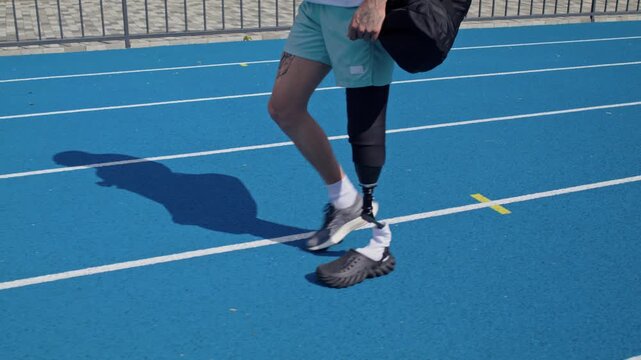 Sportsman with bionic prosthesis instead of leg walks along track