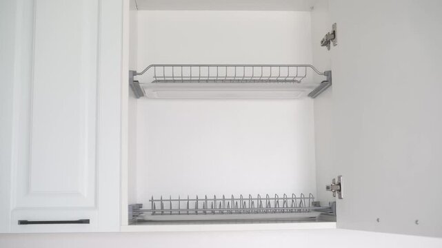 Open kitchen cabinet with metal dish rack