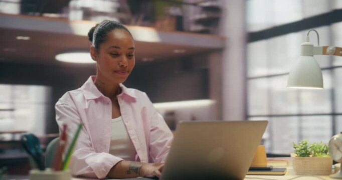 360 Degree. Confident Black Woman Types on Laptop in Office, Optimizing Ecommerce Workflow and Payment Data With Digital Software to Boost Productivity and Business Success. Cinematic Tracking Shot