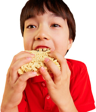 Boy biting dry instant noodle block on transparent background. Concept of instant food marketing, safety education, snack campaigns, pediatric nutrition and editorial content.