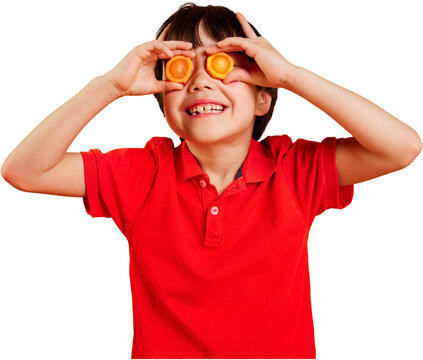 Playful boy covering eyes with carrot slices on transparent background. Concept of produce marketing, nutrition education, school meal campaigns, grocery advertising and wellness apps.