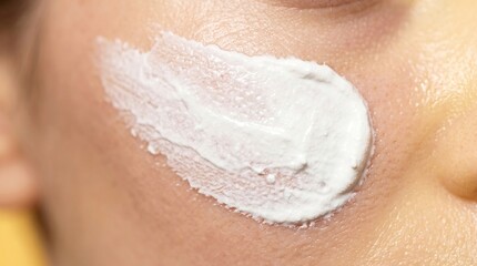 Fototapeta premium Close up of thick white cosmetic cream or healing ointment smeared on cheek