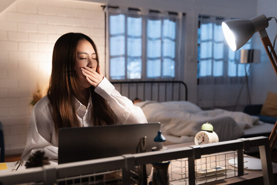 Tired Woman Yawning While Working Laptop At Night 00 (2) in industrial and commercial environment