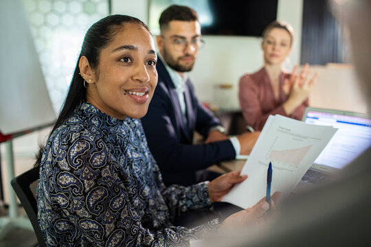 Diverse business team discussing sales report in office