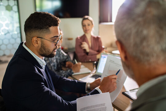 Business team reviewing financial report in modern office