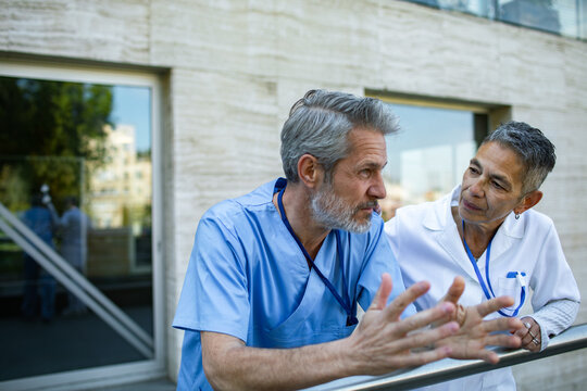 Doctors discussing case outside hospital building
