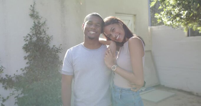 Couple, woman placing left arm over man's shoulder leaning head holding hands posing for cam watch