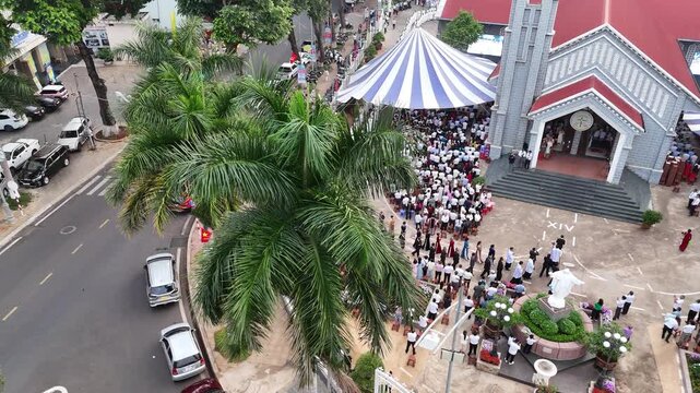 Telephoto Drone Reveal of Priests and Newly Ordained Priests Entering Buon Ma Thuot Cathedral During Ordination Ceremony