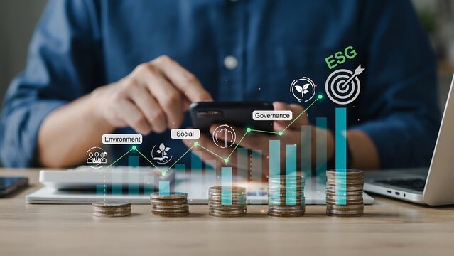 A person analyzes financial data on a smartphone at a desk with a laptop and coins, focusing on business growth and investment.