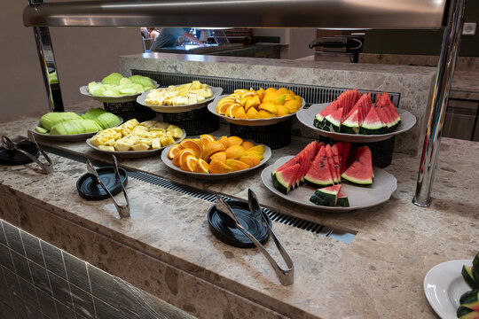 Slices of fresh tropical fruits at hotel restaurant buffet