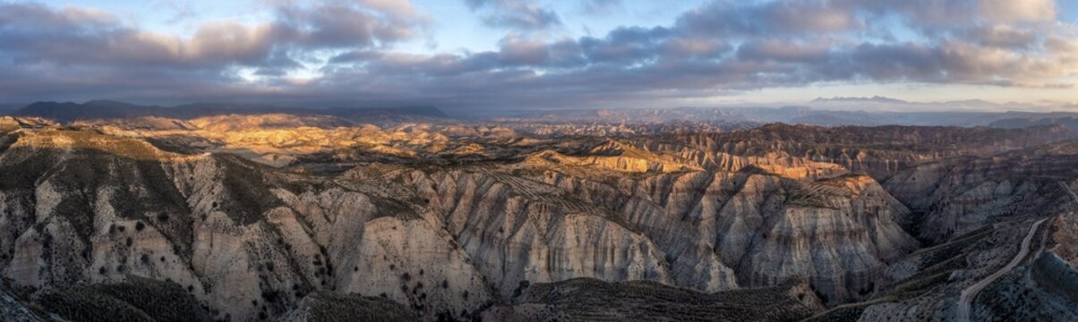 Sunrise, wide hilly desert landscape with dry vegetation, Gorafe desert, semi-desert, Granada, Andalusia, Spain