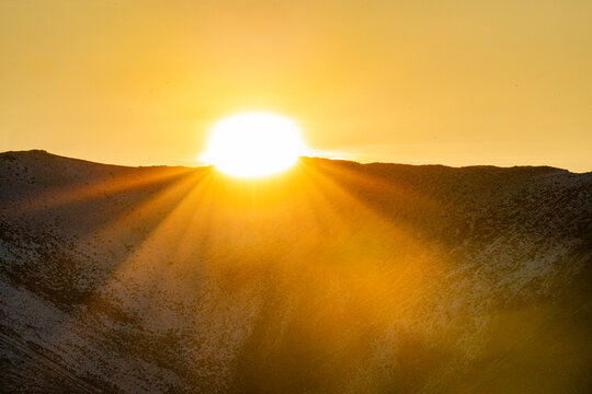 Sun setting over hills