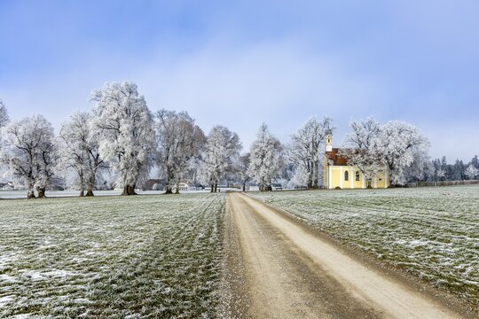 A narrow path across snow-covered fields to the church