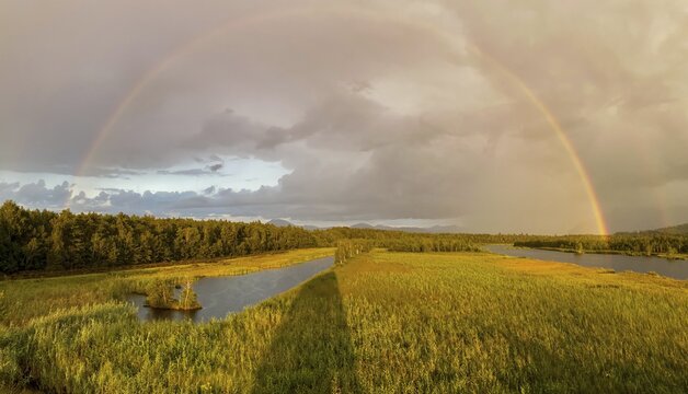 Complete and partial double rainbow in the Ainringer and Peracher moss nature reserve, Bavaria, Germany
