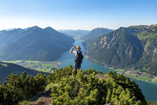 Hiker looks into the distance, view from B&auml;renkopf to Achensee, left Seekarspitze and Seebergspitze, right Rofangebirge, Karwendel, Achensee, Tyrol, Austria