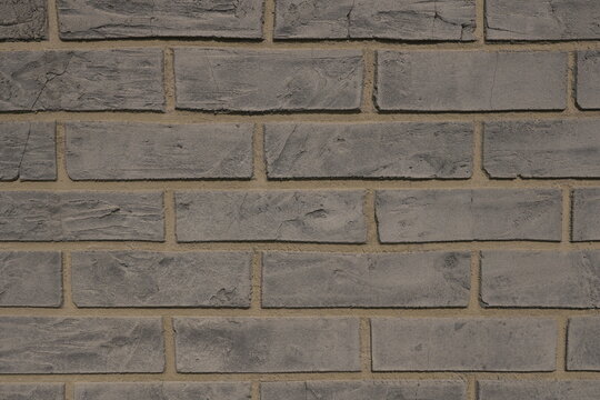 Weathered Grey Brick Wall Textured Surface with Visible Mortar Lines Abstract Background for Construction and Design Concepts