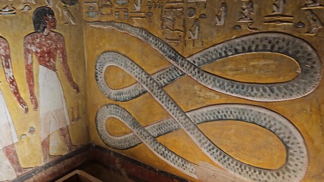 Close-up of ancient Egyptian relief carving inside KV17 tomb of Seti I, Valley of the Kings, Luxor, Egypt, showing a deity figure with black hair and deteriorating pigment.