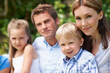 Fototapeta premium Portrait, parents and kids with smile in nature for love, summer holiday or bonding together. Happy, family and people with children in park for connection, weekend break and vacation or trip outdoor