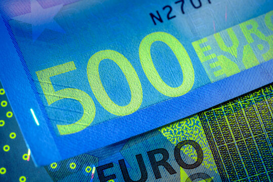 Euro banknotes glow under ultraviolet light. Verifying the authenticity.