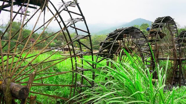 Traditional Wooden Water Wheel in Vietnam Rice Fields Ancient Hydraulic Irrigation System for Sustainable Agriculture and Rural Farming Landscape