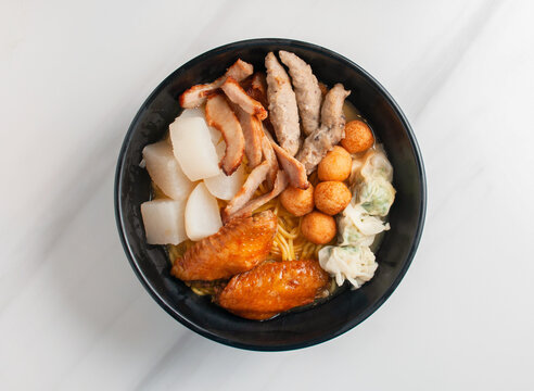 Noodles served with chicken dumplings fish balls and assorted meats
