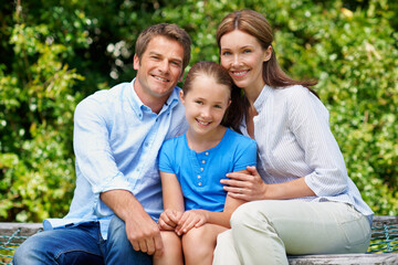 Fototapeta premium Parents, child and portrait with hug in park for holiday, outdoor trip or bonding together. Mom, dad or daughter with smile or love for family outing, connection or support on weekend in nature