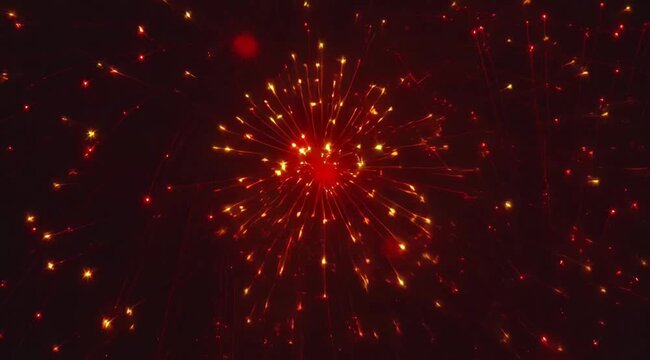 Explosion of bright red fireworks sparkling against a dark night sky, celebrating special events
