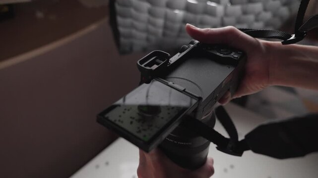 Female hands holding camera and taking photos, close-up shooting process