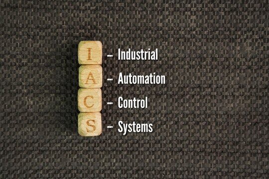 Alphabet with word Industrial Automation and Control Systems IACS. the integrated hardware, software, and network infrastructures used to monitor, manage, and automate industrial processes.
