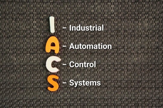 Alphabet with word Industrial Automation and Control Systems IACS. the integrated hardware, software, and network infrastructures used to monitor, manage, and automate industrial processes.
