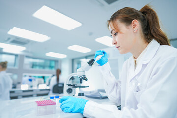 Fototapeta premium Medical pathologist executing diagnostic blood smear protocol for hematological screening. Clinical laboratory scientist detecting pathogen presence on glass interface.