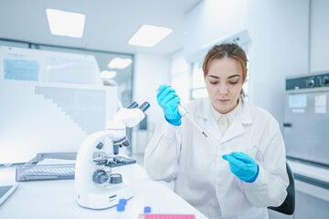 Fototapeta premium Clinical cytologist preparing histological specimen slide via precision micropipette technique. Female researcher applying reagent stain for microscopic morphology analysis.