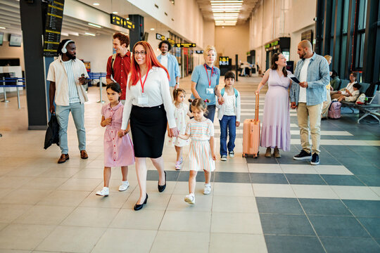 Group of people traveling through modern airport terminal