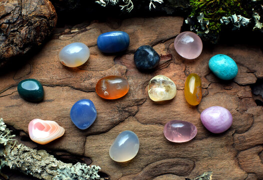 Multicolored natural semi-precious stones on a wooden background. Healing crystals.