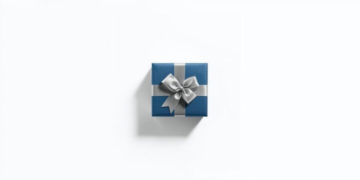 Blue gift box with silver ribbon and bow on white background